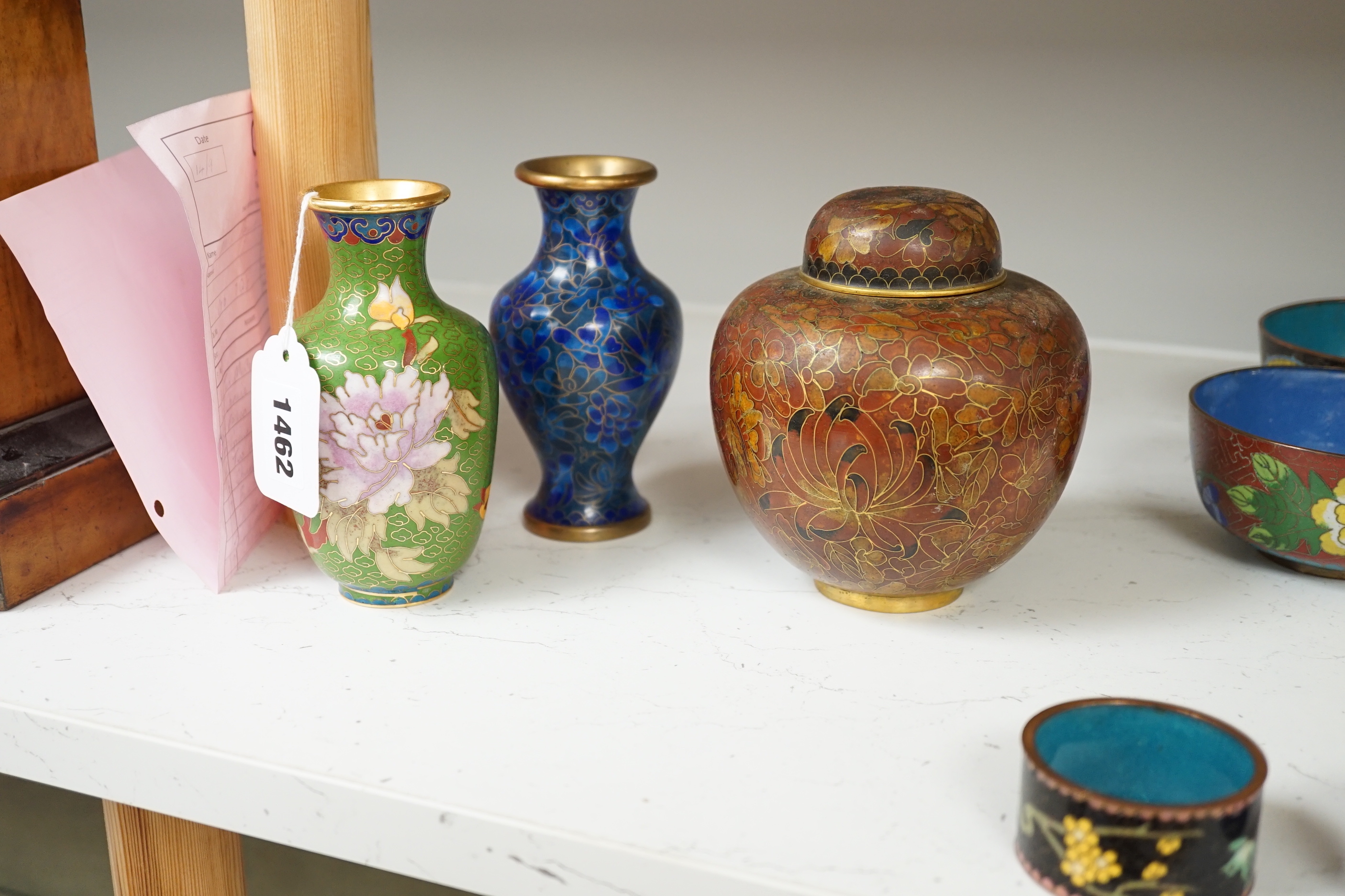 A collection of Chinese and Japanese cloisonné enamel pieces, including five vases, a ginger jar and cover, three bowls, a miniature teapot, napkin rings, etc. (19)